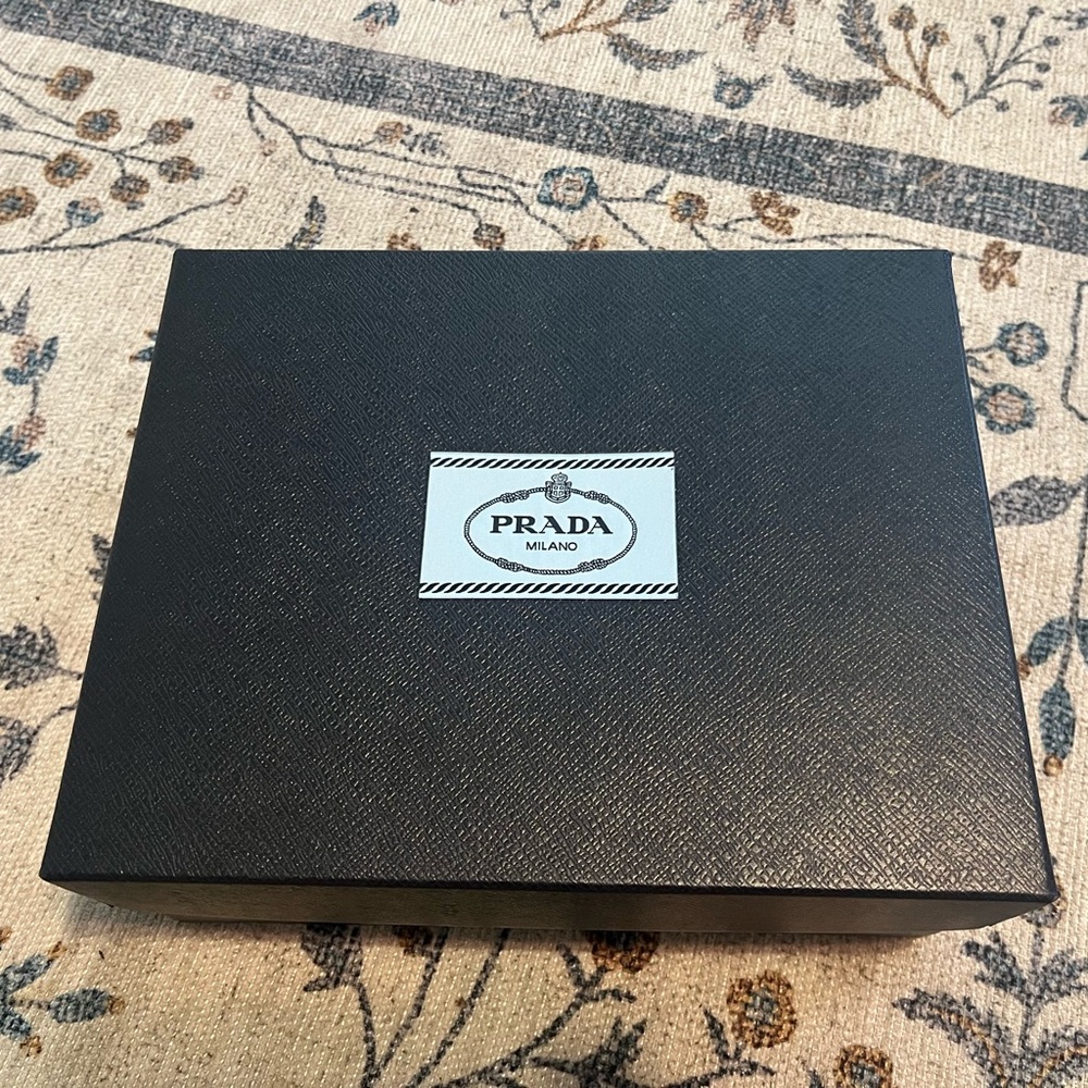 Prada storage box with wrap on gift belt.